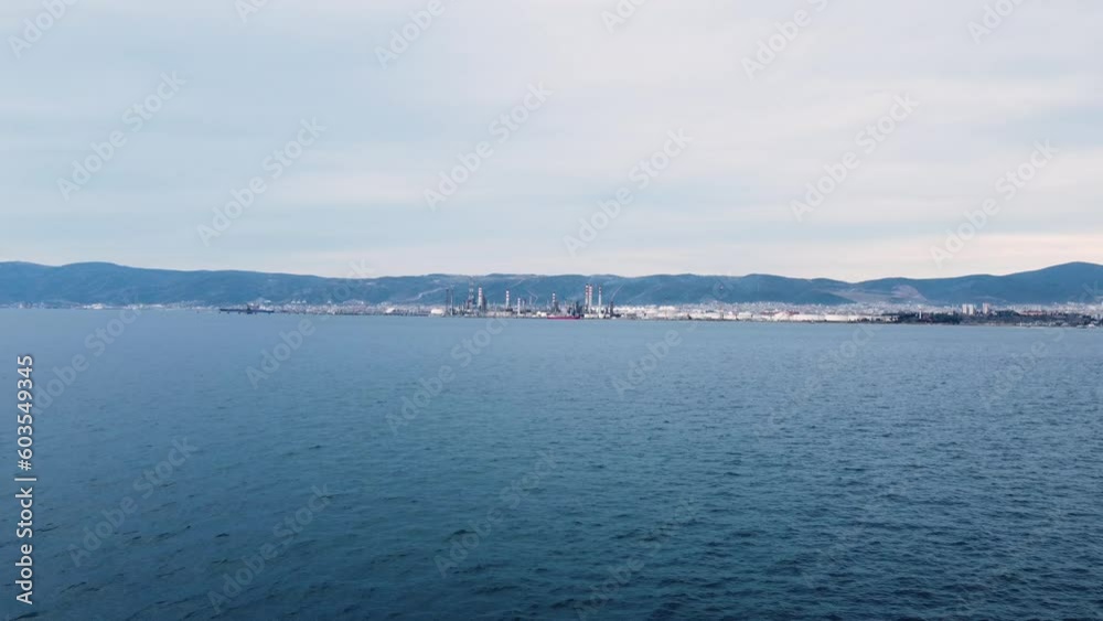 Aerial view of oil refinery plant. Drone view of an oil refinery plant across the sea. World environment day concept. Aerial view of oil refinery plant. Drone view of an oil refinery plant across the sea. World environment day concept.