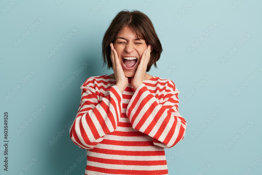 Excited woman screaming happily in studio Excited woman screaming happily in studio