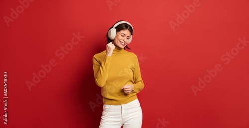 Smiling woman listening to music in headphones