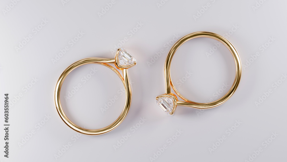 Top view of two gold rings with square diamonds on white background from design with 3d render. Top view of two gold rings with square diamonds on white background from design with 3d render.