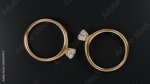 Top view of two gold rings with square diamonds on black background from design with 3d render.