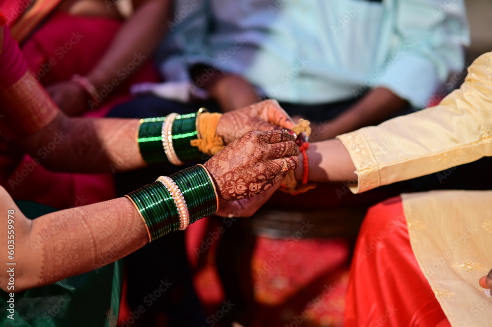 Hindu Bride Wearing Turmeric Thread on a Groom hand. Kanyadaan Ceremony