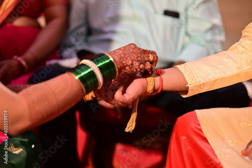 hands of the bride and groom in Kanyadaan Ceremony. Turmeric Thread. Kanyadana (Sanskrit: कन्यादान, romanized: Kanyādāna) Hindu wedding ritual. photo