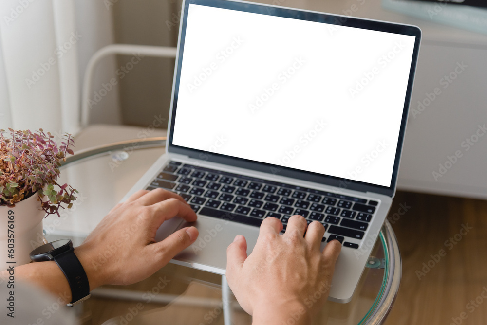 hand using laptop and typing on keyboard with mockup of blank screen. hand using laptop and typing on keyboard with mockup of blank screen.