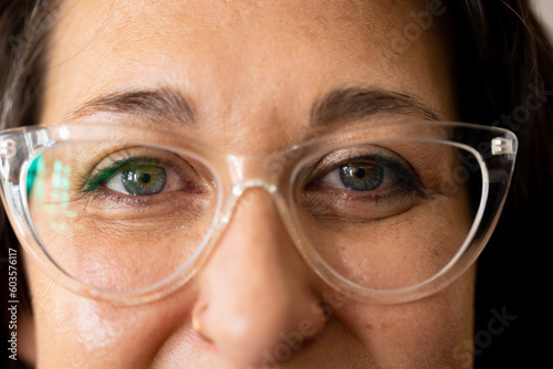 Portrait of happy caucasian female worker in glasses smiling to camera at jewellery workshop