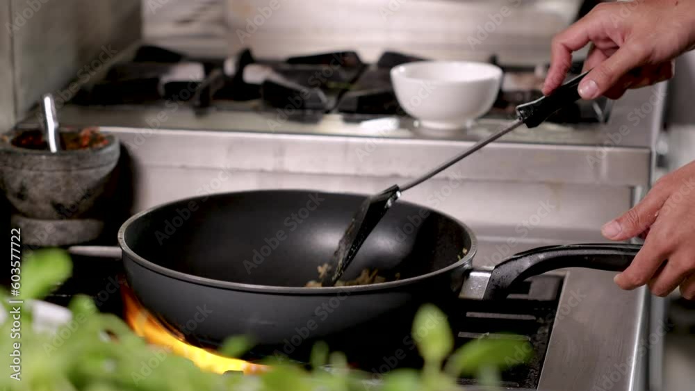 Hands of chef students trainee cooking chineses food in hot pan, chef with white uniform, young chef in cooking school try to make hot soup,chef put fat oil to hot pan waiting for next step cooking Hands of chef students trainee cooking chineses food in hot pan, chef with white uniform, young chef in cooking school try to make hot soup,chef put fat oil to hot pan waiting for next step cooking