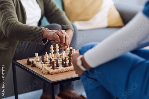 Hands, chess a nurse with a patient in a nursing home playing a game of strategy during a visit. Healthcare, medical or insurance with a medicine professional and resident in the living room together