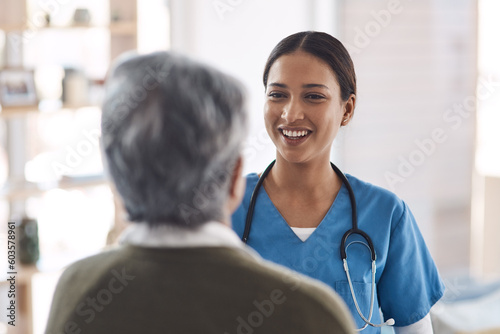 Healthcare, smile and a nurse talking to an old woman about treatment in a nursing home facility. Medical, happy and a female medicine professional chatting to a senior resident during a visit photo