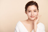 Beautiful young asian woman with clean fresh skin on beige background, Face care, Facial treatment, Cosmetology, beauty and spa, Asian women portrait.