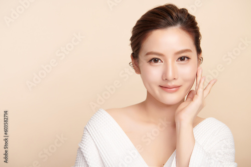 Beautiful young asian woman with clean fresh skin on beige background, Face care, Facial treatment, Cosmetology, beauty and spa, Asian women portrait.