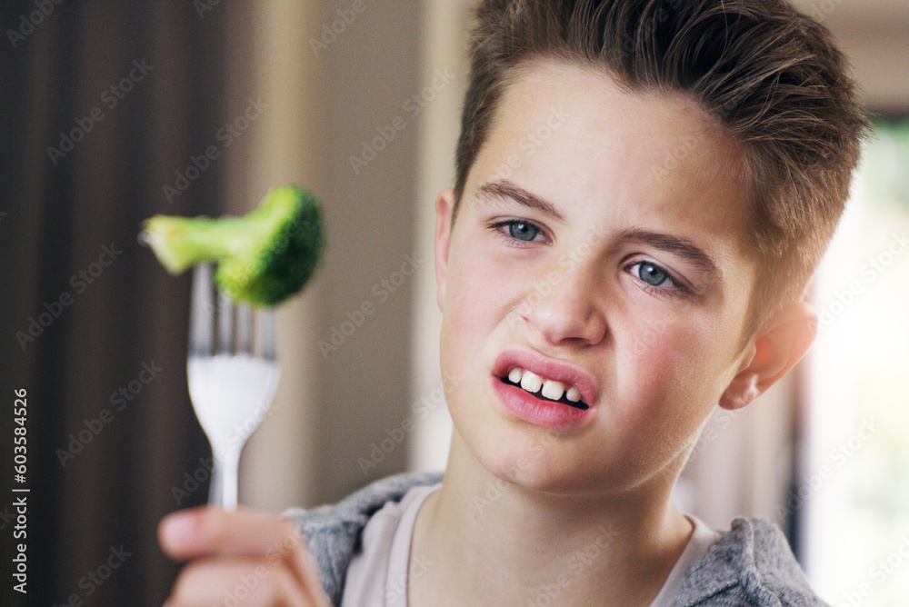 Disgust, food and fear with child and broccoli for nutrition, health and cooking. Sad, angry and dinner with boy and refuse to eat vegetable at home for eating problem, frustrated and dislike