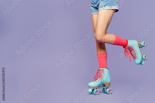 Принти на полотні Close up cropped female raised up legs in rollerblades rollers isolated on pastel plain light purple violet background studio
