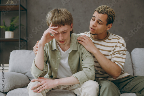 Canvas Print Young upset sad dissatisfied couple two gay men wear casual clothes together apo
