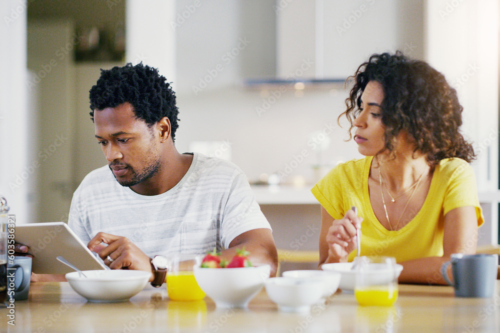 Tablet, breakfast and couple in kitchen online for social media, internet and app in morning. Marriage, love and curious woman looking at man on digital tech for website browse, search and network Tablet, breakfast and couple in kitchen online for social media, internet and app in morning. Marriage, love and curious woman looking at man on digital tech for website browse, search and network