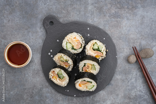 Korean Rolled Gimbap, made of rice, cucumber, tuna, carrot, sausage, crab stick and wrapped with seaweed laver. 
