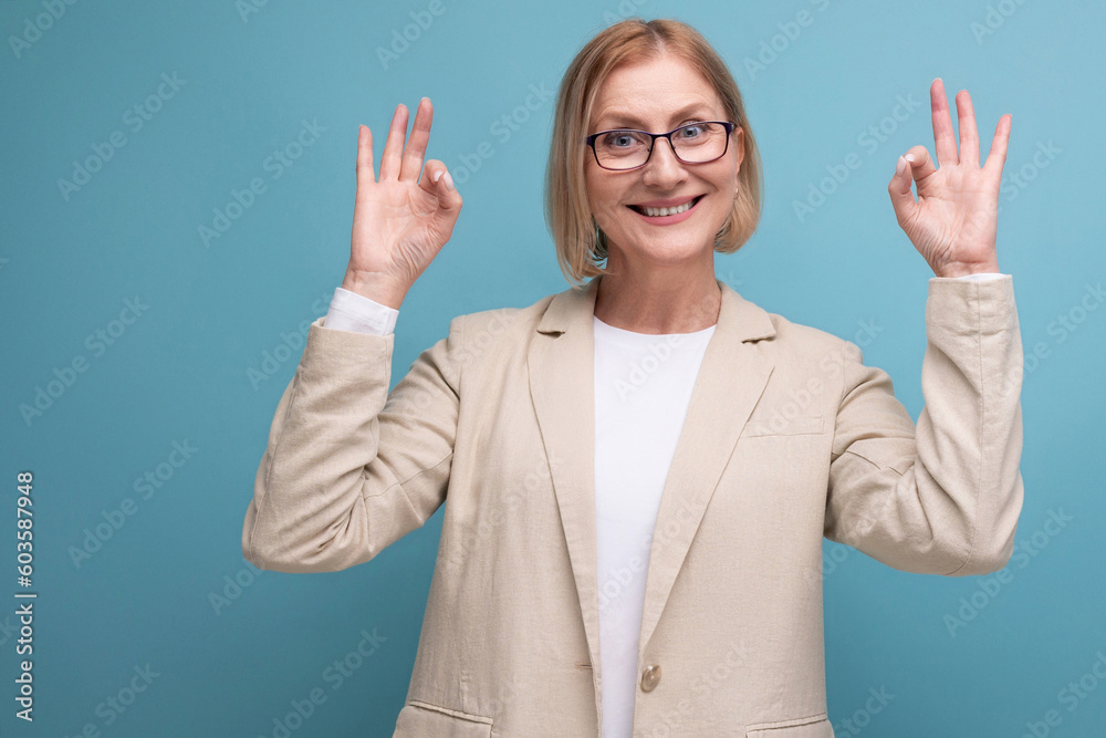 joyful smiling 50s mature woman smiling on plain background with copy space joyful smiling 50s mature woman smiling on plain background with copy space