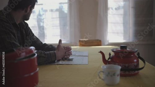 Bored man playing with his thumbs at home kitchen, static view