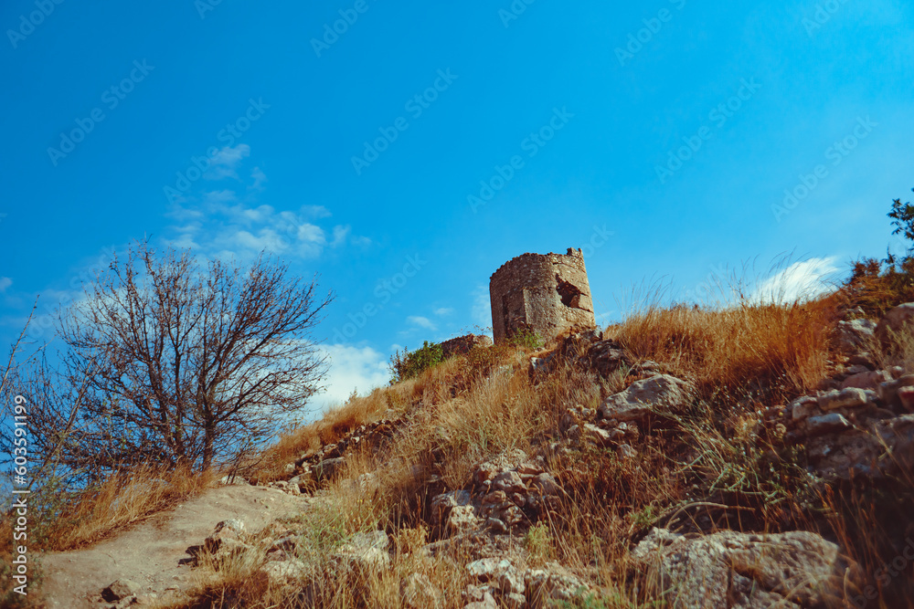 an ancient stone tower on a blue sky background