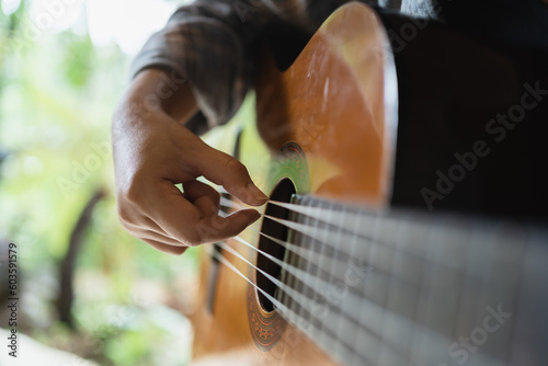 Happy young Woman hands playing acoustic guitar musician  alone compose instrumental song lesson on playing the guitar photo