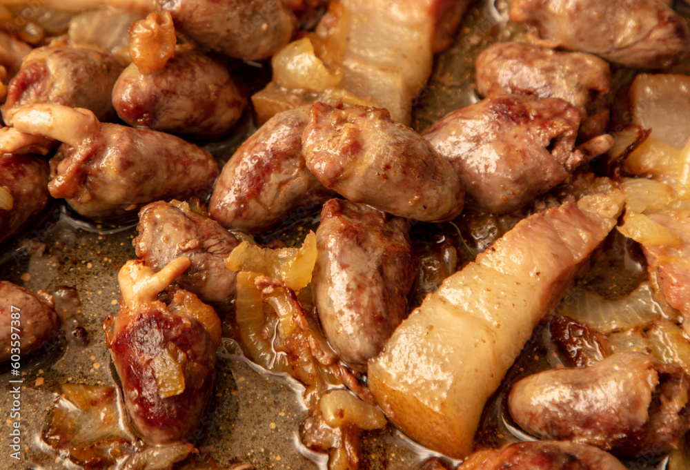 Chicken hearts are fried in a pan in oil Chicken hearts are fried in a pan in oil