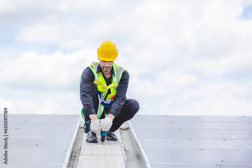 Male professional engineer installing solar photovoltaic panel system, Electrician mounting blue solar module technology on power industrial factory roof, Alternative energy ecological technician job Male professional engineer installing solar photovoltaic panel system, Electrician mounting blue solar module technology on power industrial factory roof, Alternative energy ecological technician job