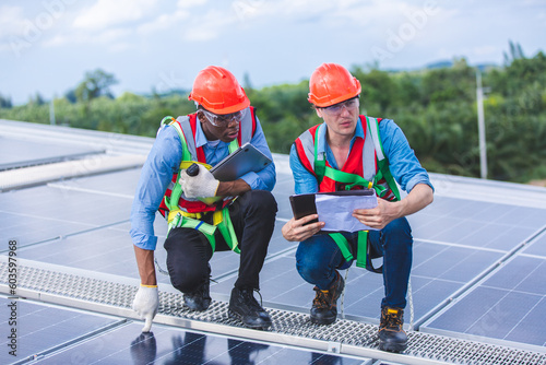 Wallpaper Mural Male professional engineer installing solar photovoltaic panel system, Electrician mounting blue solar module technology on power industrial factory roof, Alternative energy ecological technician job Torontodigital.ca