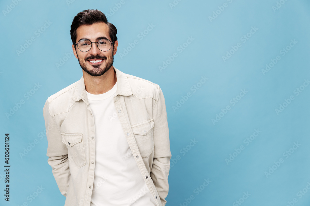 Portrait of a stylish man smile glasses for farsightedness and myopia, on a blue background in a white T-shirt, space space Portrait of a stylish man smile glasses for farsightedness and myopia, on a blue background in a white T-shirt, space space
