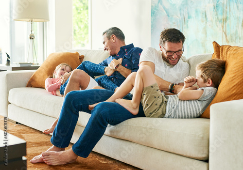 Tableau sur toile Gay parents, family fun and living room with dads and kids together with laugh and tickle