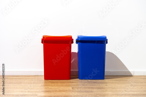 Plastic waste bin with lid in the room