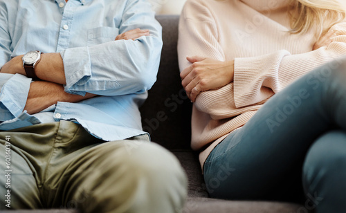 Divorce, sad and couple fight due on a couch due to marriage problem or conflict in a lounge sofa. Anger, fail and angry people or partner frustrated in a living room due to cheating or argument