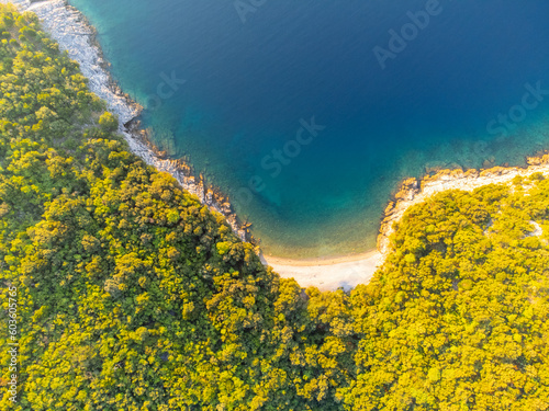 Bild auf Leinwand Rocky cliffs with small beach and blue sea on sunny summer day