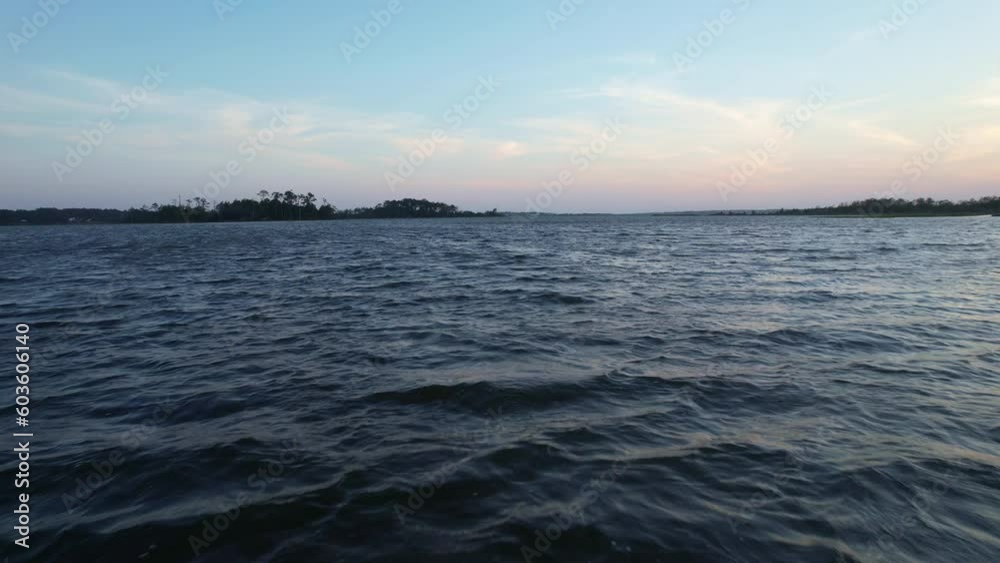 Cinematic aerial shot of water in the sound or marsh, flying low to the water Cinematic aerial shot of water in the sound or marsh, flying low to the water