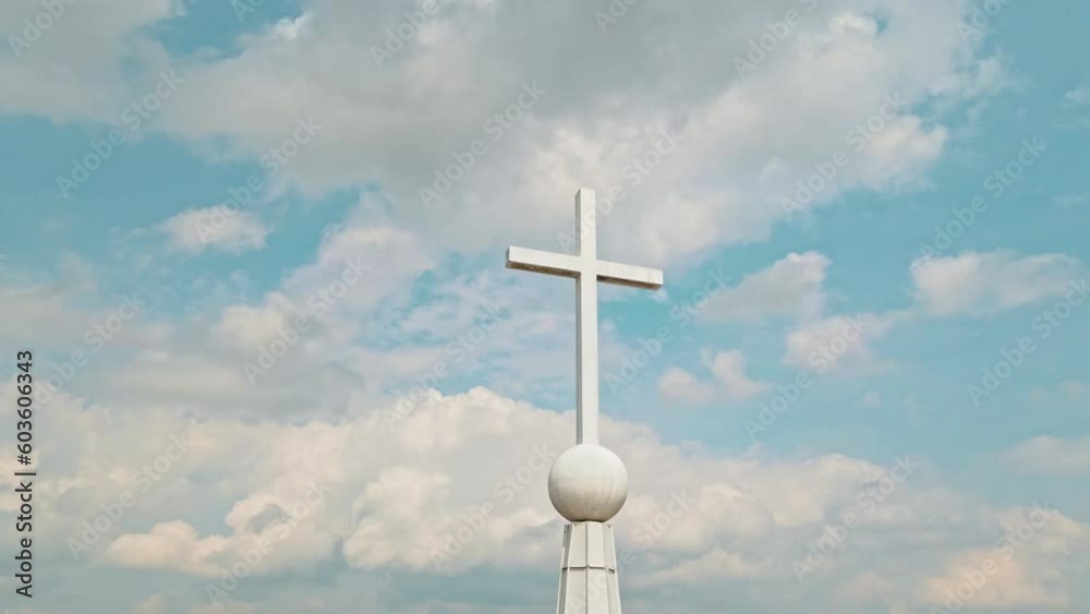Curve drone shot of a white cross on top of a steeple. Curve drone shot of a white cross on top of a steeple.