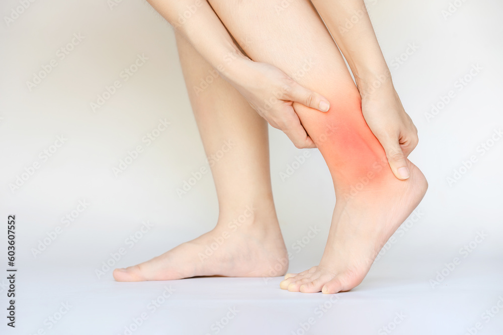 A woman's ankle pain on a white background. A woman's ankle pain on a white background.
