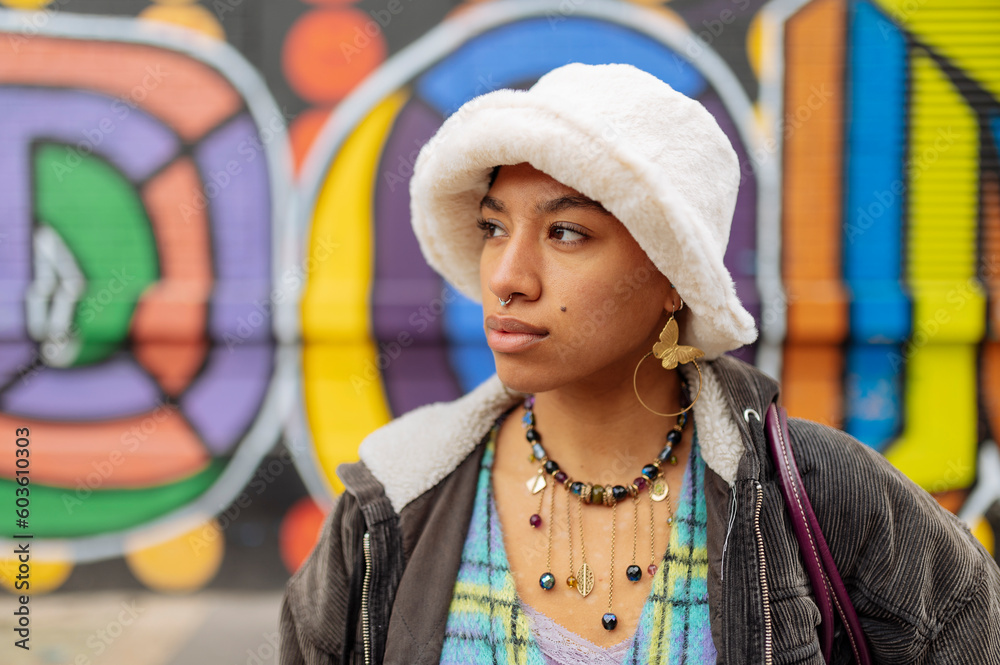 Hipster young woman in bucket hat standing outdoors Hipster young woman in bucket hat standing outdoors