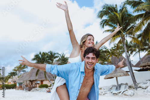 Hispanic young couple in love man and woman having fun on caribbean beach in holidays or vacations in Mexico Latin America photo