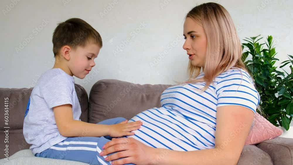 A pregnant woman hugs her eldest son. Selective focus. A pregnant woman hugs her eldest son. Selective focus.