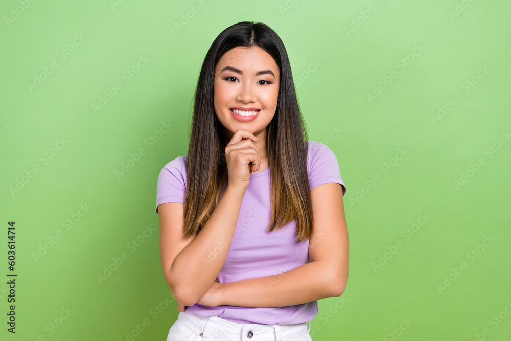 Photo portrait of pretty vietnamese chinese young girl touch chin thinking dressed stylish violet outfit isolated on green color background Photo portrait of pretty vietnamese chinese young girl touch chin thinking dressed stylish violet outfit isolated on green color background