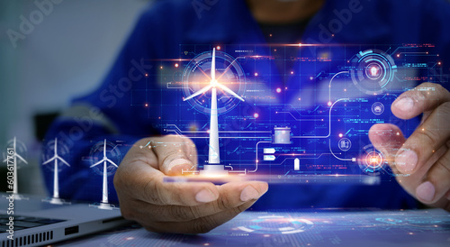 Engineer view a dashboard hud The program shows the total power generated by wind turbines and displays them on the hologram screen. Clean energy technology and renewable energy. photo