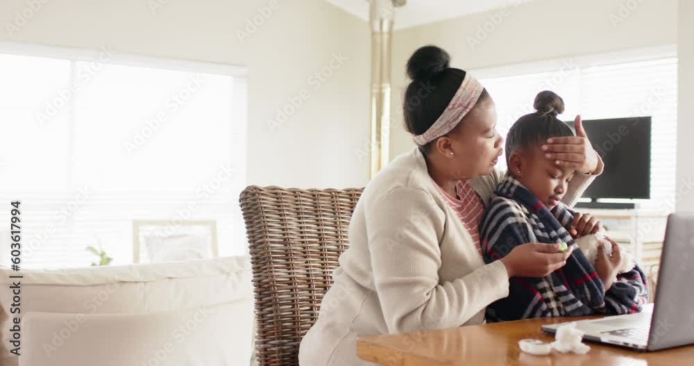 Unaltered african american mother and sick daughter using laptop for doctor video call, slow motion Unaltered african american mother and sick daughter using laptop for doctor video call, slow motion