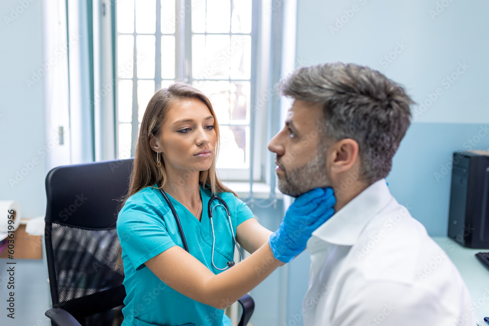Endocrinologist examining throat of man in clinic. Men with thyroid gland test . Endocrinology, hormones and treatment. Inflammation of the sore throat - obrazy, fototapety, plakaty 