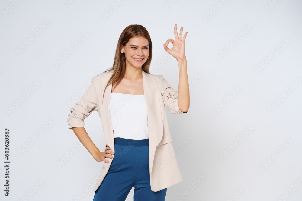 Portrait of young woman showing OK sign isolated on white background. Portrait of young woman showing OK sign isolated on white background.
