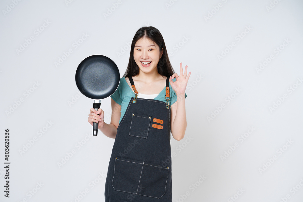 Restaurant owner sme woman showing OK sign and holding pan isolated on white background. Restaurant owner sme woman showing OK sign and holding pan isolated on white background.