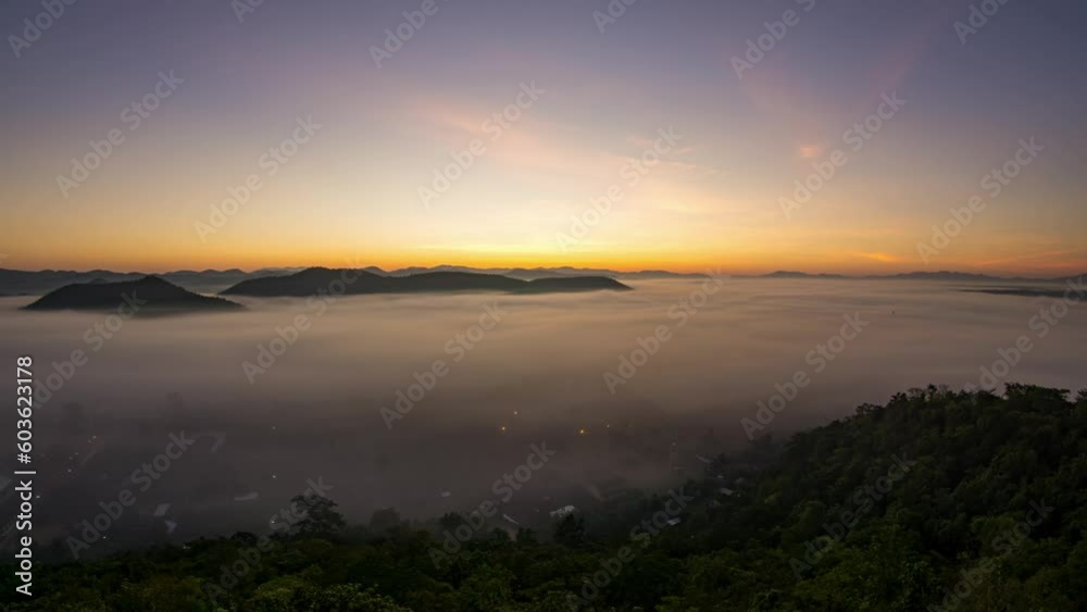 The fog movement. It's the same as the waves of the sea. Orange light in the morning at sunrise.Time-lapse at Muang Lee Viewpoint, Lamphun, Thailand The fog movement. It's the same as the waves of the sea. Orange light in the morning at sunrise.Time-lapse at Muang Lee Viewpoint, Lamphun, Thailand