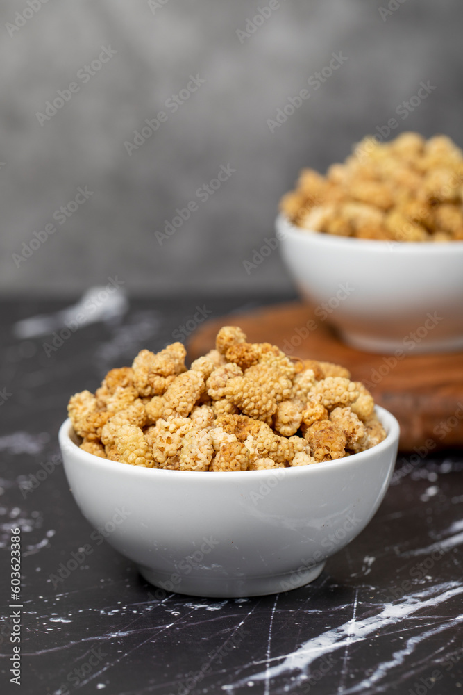 Dried mulberry. Sun-dried mulberry in ceramic bowl. superfood. Vegetarian food concept. healthy snacks. Close up Dried mulberry. Sun-dried mulberry in ceramic bowl. superfood. Vegetarian food concept. healthy snacks. Close up
