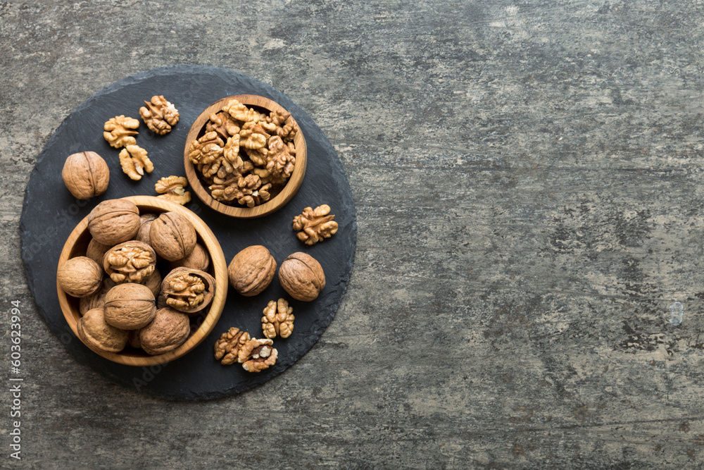 Fresh healthy walnuts in bowl on colored table background. Top view Healthy eating bertholletia concept. Super foods Fresh healthy walnuts in bowl on colored table background. Top view Healthy eating bertholletia concept. Super foods