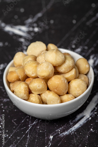 Macadamia nuts. Peeled Macadamia Nuts in a ceramic bowl. superfood. Vegetarian food concept. healthy snacks. Close up