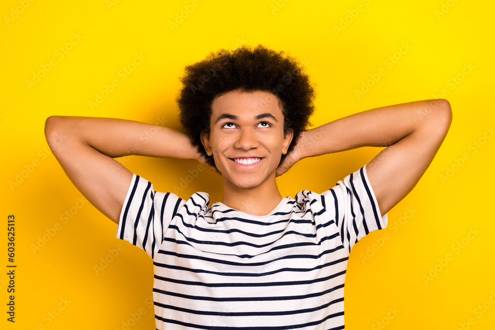 Portrait of cheerful man wear striped stylish t-shirt hands head dream positive look novelty up ideas isolated on yellow color background Portrait of cheerful man wear striped stylish t-shirt hands head dream positive look novelty up ideas isolated on yellow color background