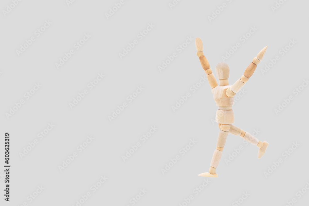 Photograph of a wooden mannequin with light gray coloured background. Photo to be able to crop. Concepts. Selective focus. Space for copy Photograph of a wooden mannequin with light gray coloured background. Photo to be able to crop. Concepts. Selective focus. Space for copy