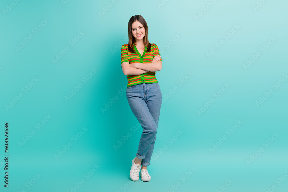 Full length photo of stunning pretty lady wear stylish clothes arm crossed presenting collection outfit isolated on cyan color background Full length photo of stunning pretty lady wear stylish clothes arm crossed presenting collection outfit isolated on cyan color background